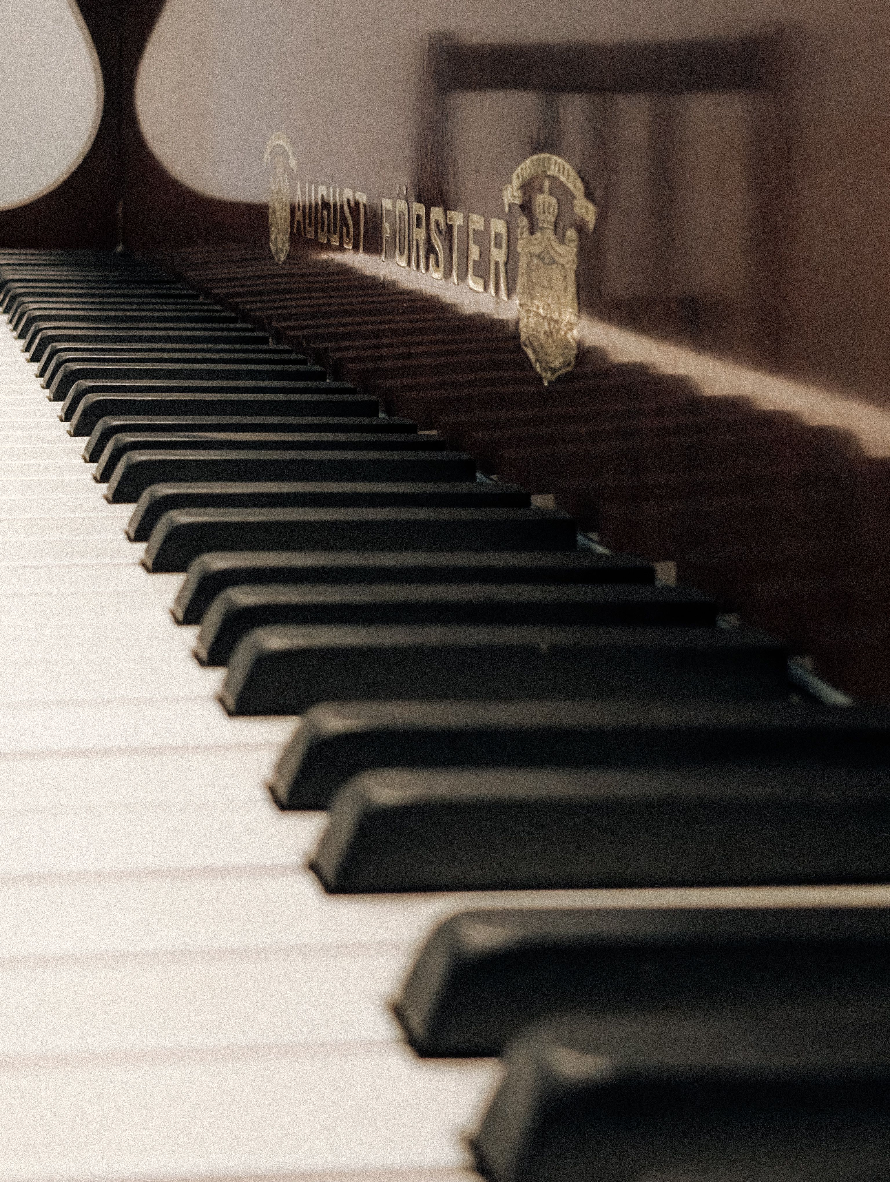 Close-up of Piano Keys with August Förster Logo · Free Stock Photo