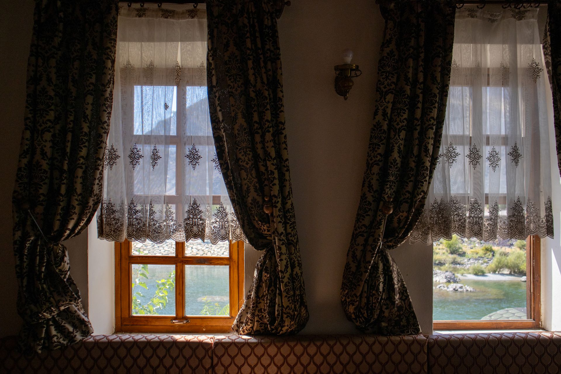 Charming view from an ornate window in Palu, Elazığ, Türkiye showing scenic nature outside.
