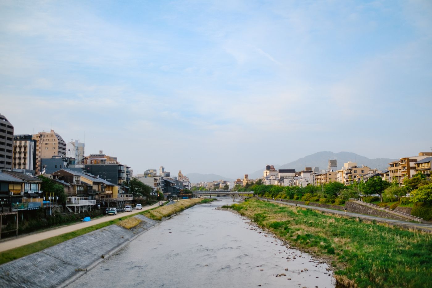 The Kamo River in Kyoto, Japan, with traditional buildings along its banks