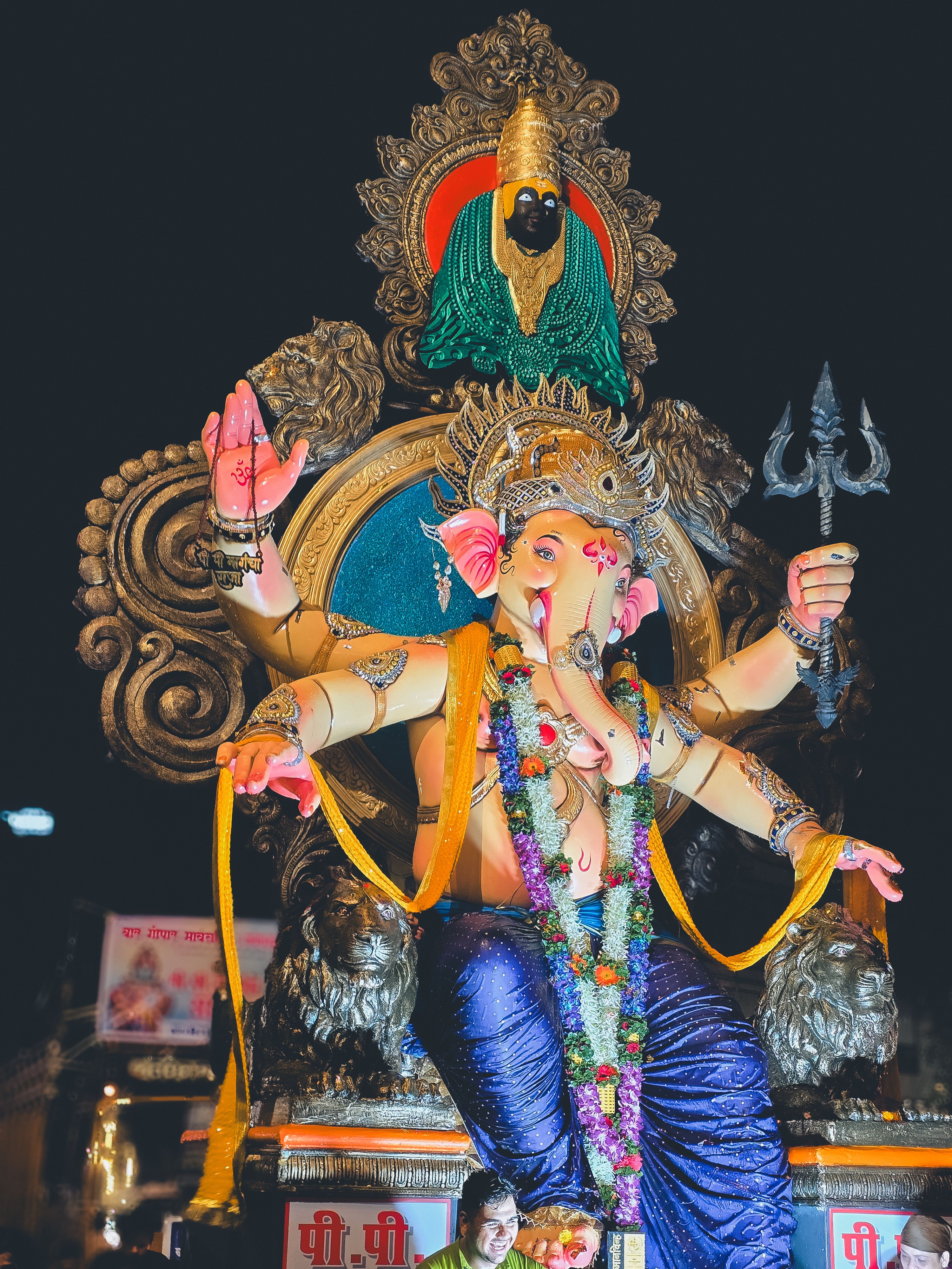 Majestic idol of Lord Ganesha adorned with vivid decorations at Mumbai's Ganesh Chaturthi festival.