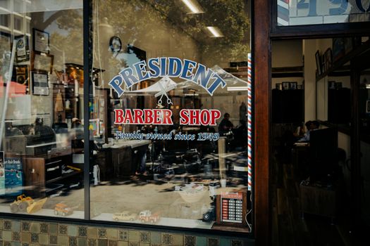 Classic barber shop in Palo Alto, California showcasing vintage charm through exterior glass window.