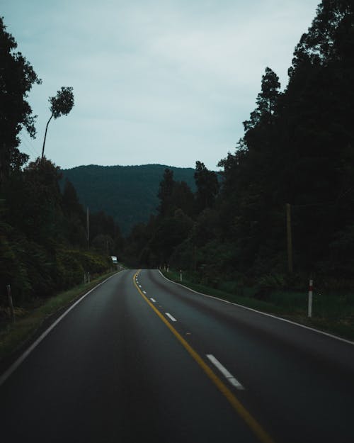 Asphalt Road Leading to a Mountain