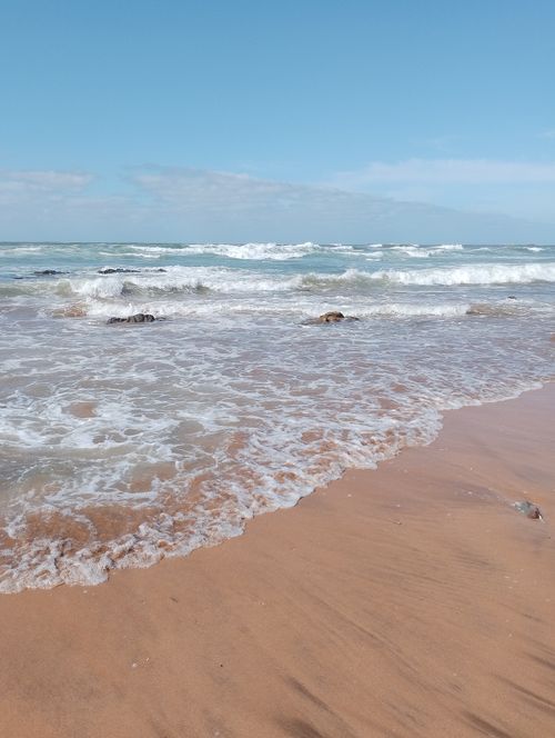Free Relaxing view of the Atlantic Ocean at a Casablanca beach with gentle waves and clear sky. Stock Photo