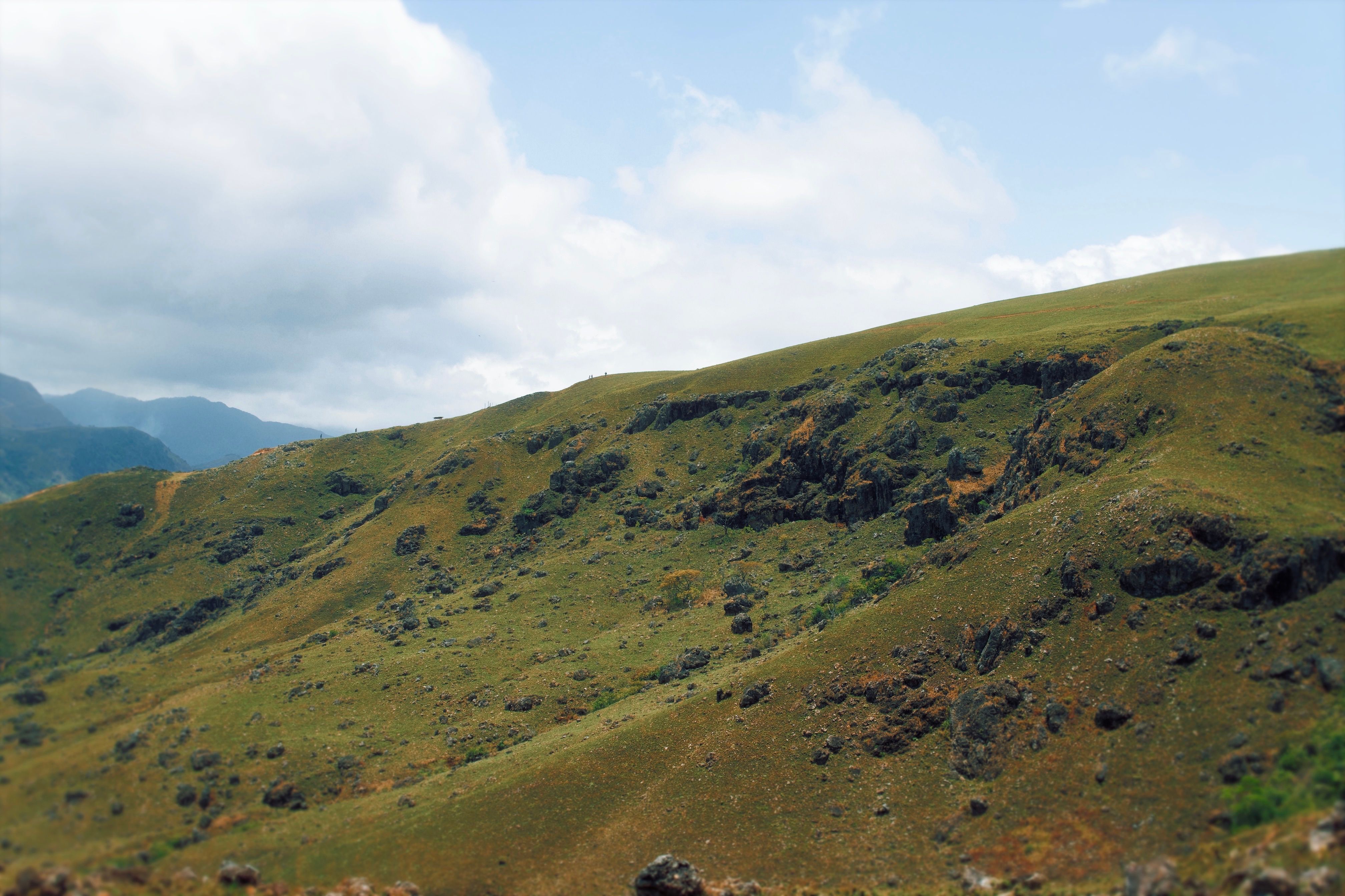 Serene Rolling Hills under Blue Sky Landscape · Free Stock Photo