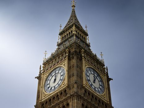A close-up view of London's famous Big Ben clock tower under a clear blue sky.