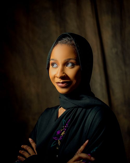 Free A beautiful portrait of a woman in traditional attire, captured with a warm and elegant vibe. Stock Photo