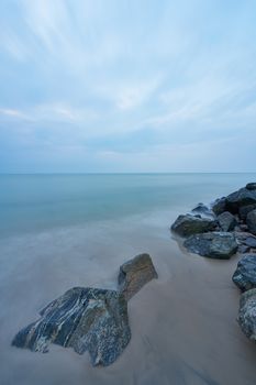 Serene coastal landscape with rocky beach in Hjørring, Denmark during a calm day.