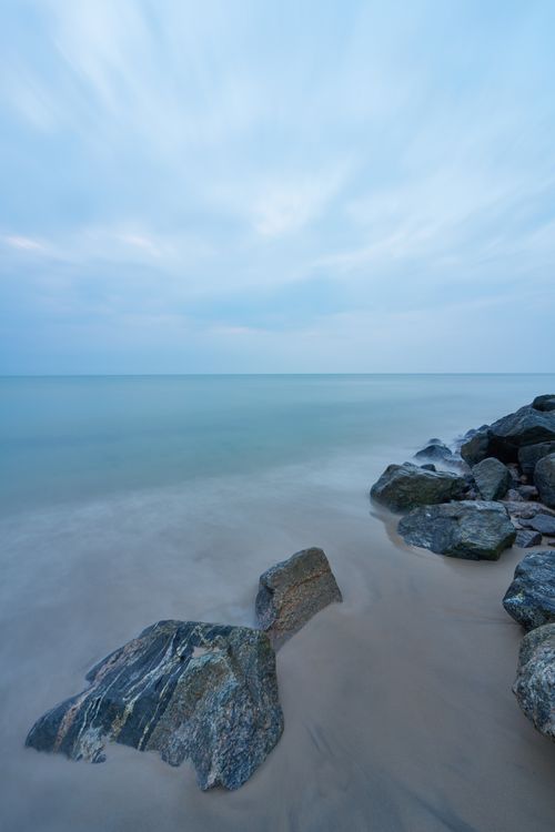 Free Serene coastal landscape with rocky beach in Hjørring, Denmark during a calm day. Stock Photo