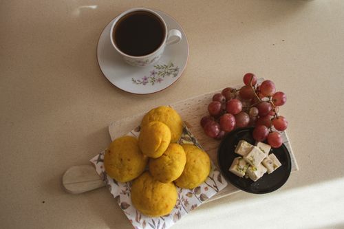 Free Flat lay of breakfast with coffee, grapes, pastries, and cheese on a sunny morning. Stock Photo