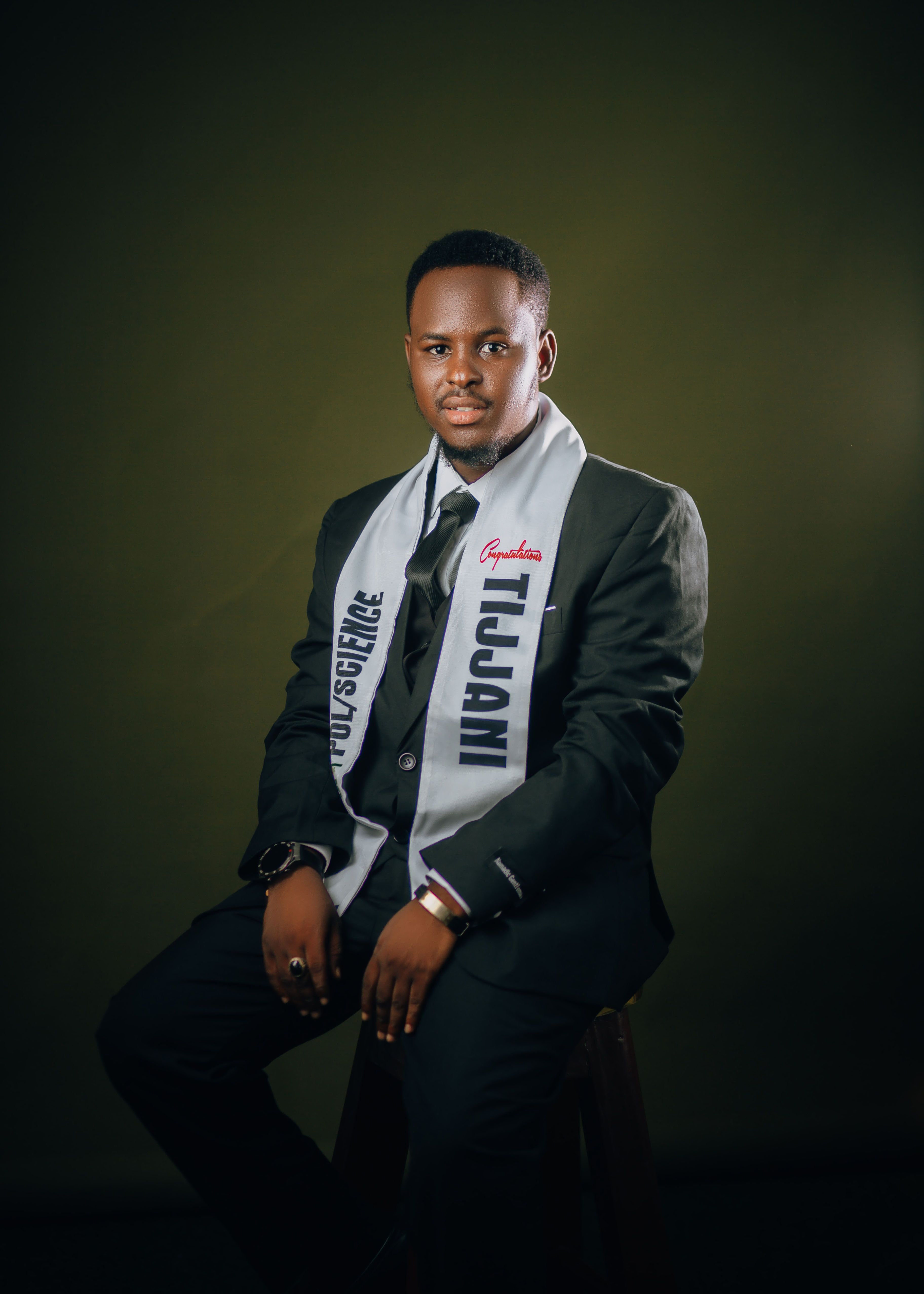 Portrait of an African man in a suit with a decorative scarf, exuding elegance and confidence.