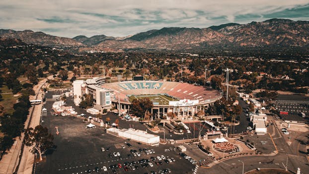 Stunning aerial view of the iconic Rose Bowl stadium in Los Angeles, surrounded by scenic mountains.