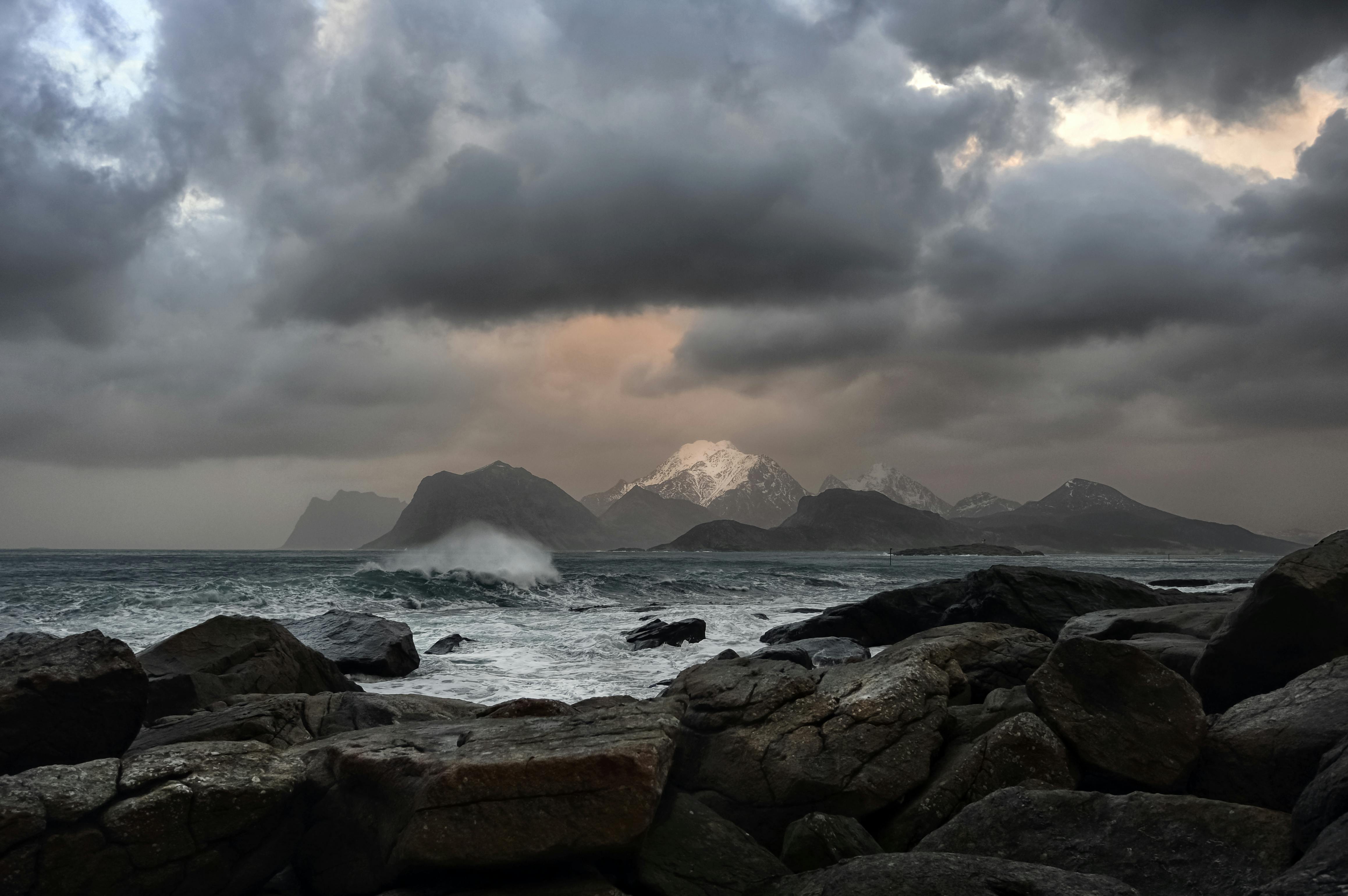 brown rock formations viewing mountain under white and gray sky