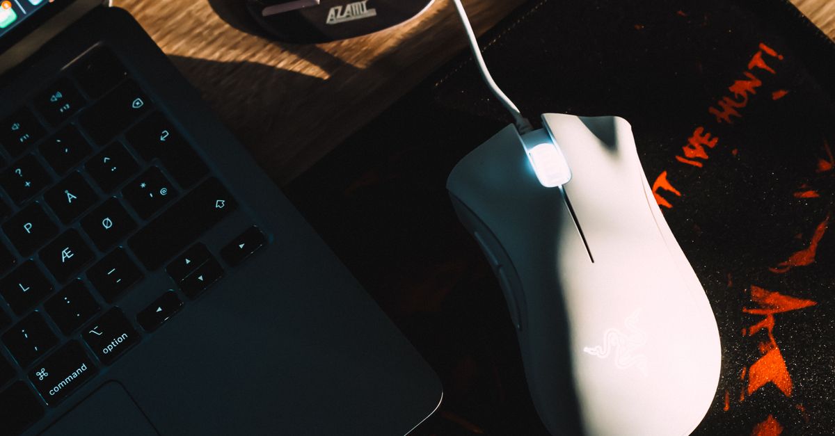 Modern Workspace with Gaming Mouse and Laptop · Free Stock Photo