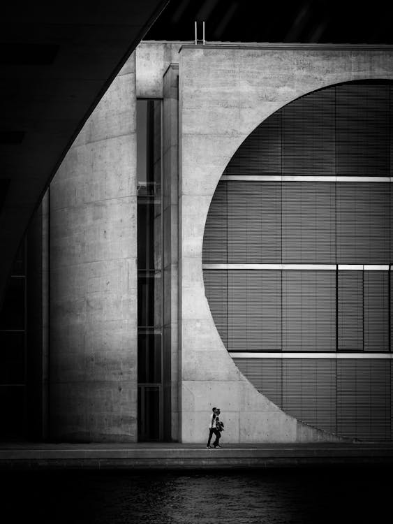 Person Walking Beside Building