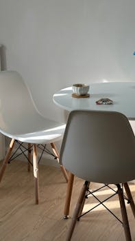 Light-filled minimalist dining area with modern chairs and table.