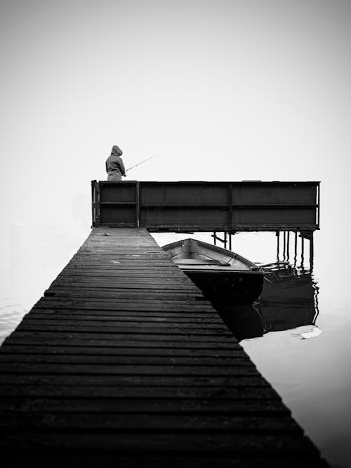 Person Fishing on Dock