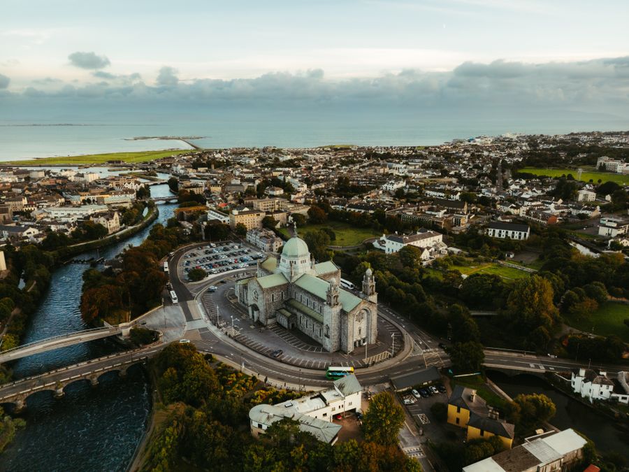 A aerial view of Galway, Ireland featuring St. Nicholas' Cathedral and surrounding landscape