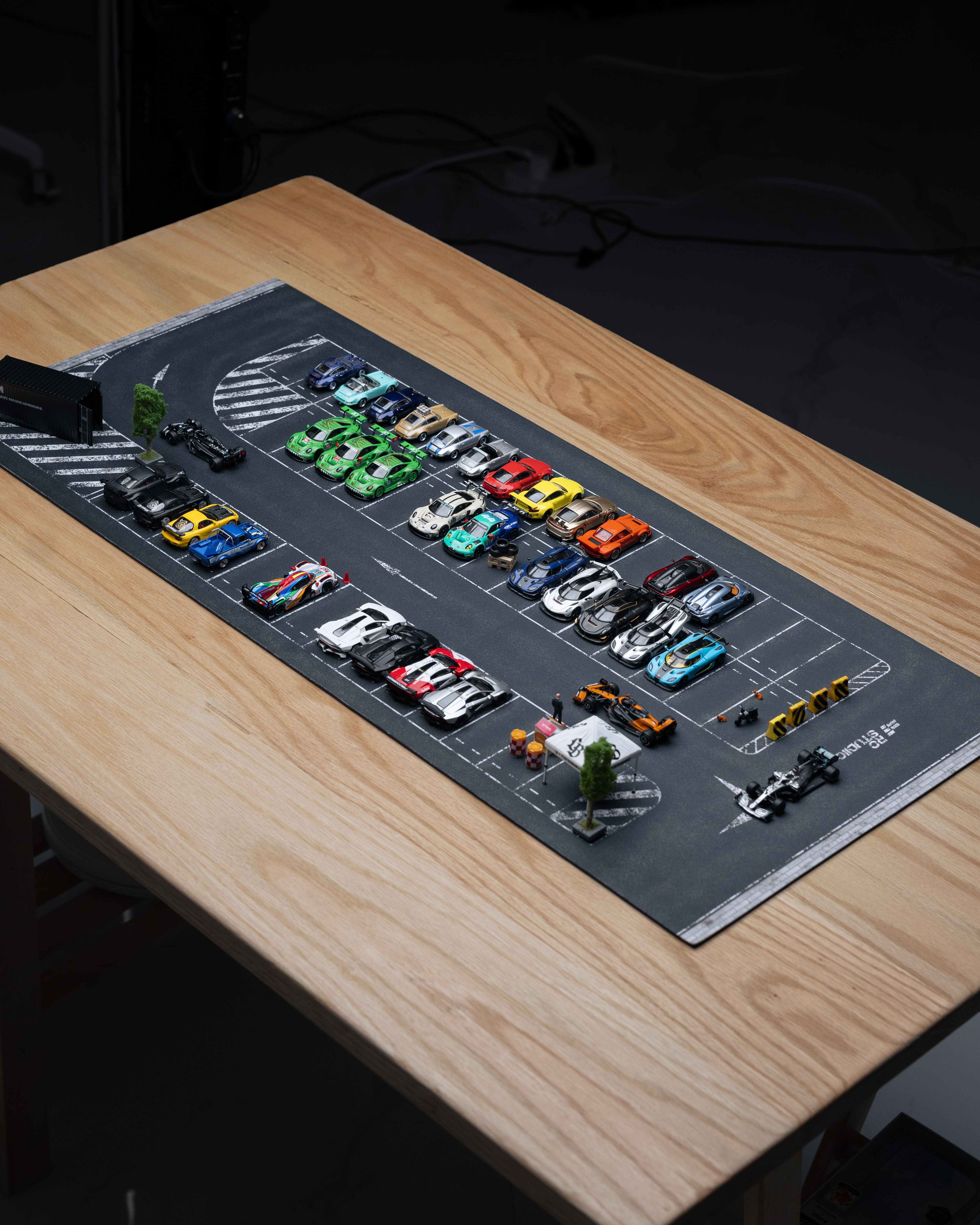 Diecast Toy Car Collection Display on Wooden Desk · Free Stock Photo