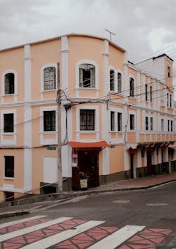 A charming colonial-style building on a quiet city street with warm tones and architectural details.