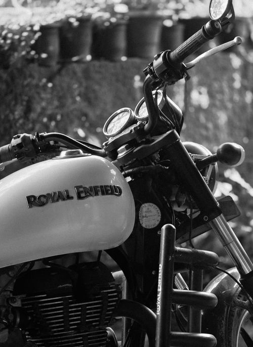 Free Close-up view of a Royal Enfield motorcycle captured in elegant black and white tones. Stock Photo