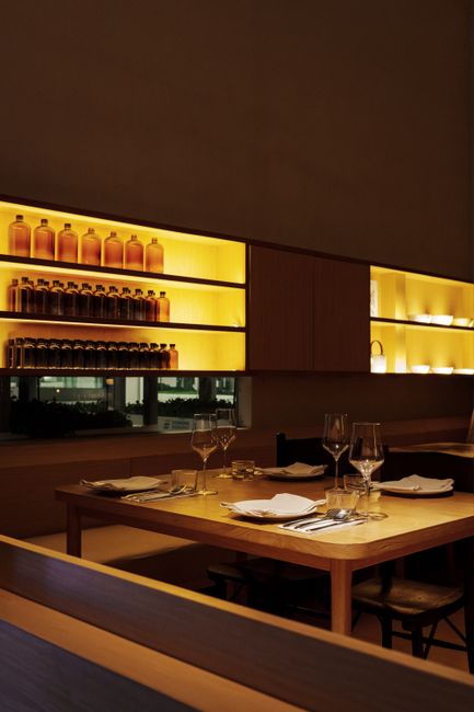 Cozy and elegant dining table in a modern restaurant with soft lighting, set for a relaxing meal.