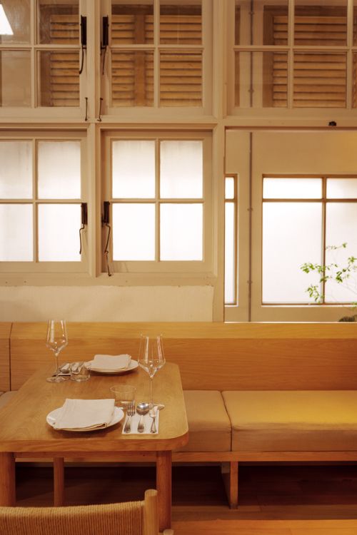 Free Warm and inviting cafe interior in George Town, Malaysia, featuring wooden furniture and soft lighting. Stock Photo