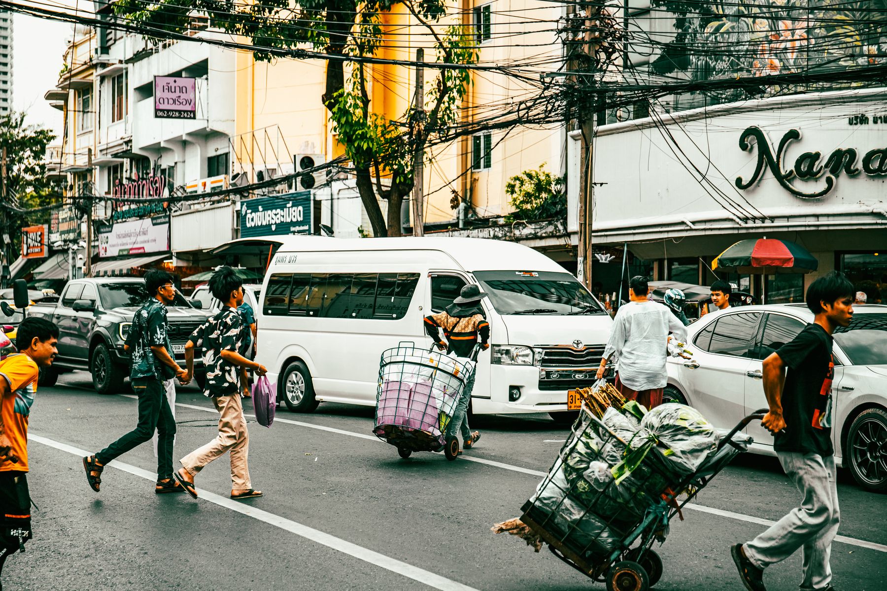 A busy Bangkok street-food stall serving cheap cooked dishes to locals.