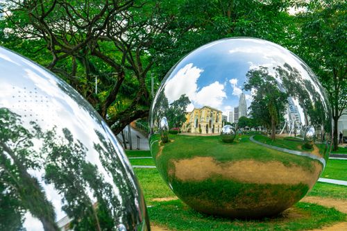 Free Stunning art installation of reflective spheres in a lush Singapore park. Stock Photo