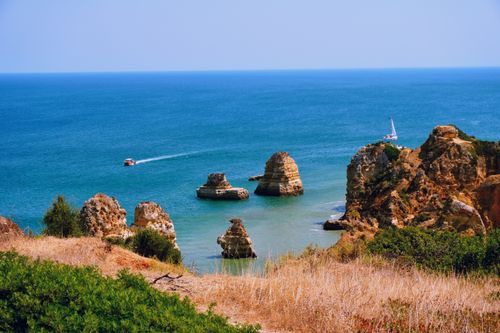 Free Stunning Algarve coast with rocks in turquoise waters, perfect for travel and nature content. Stock Photo