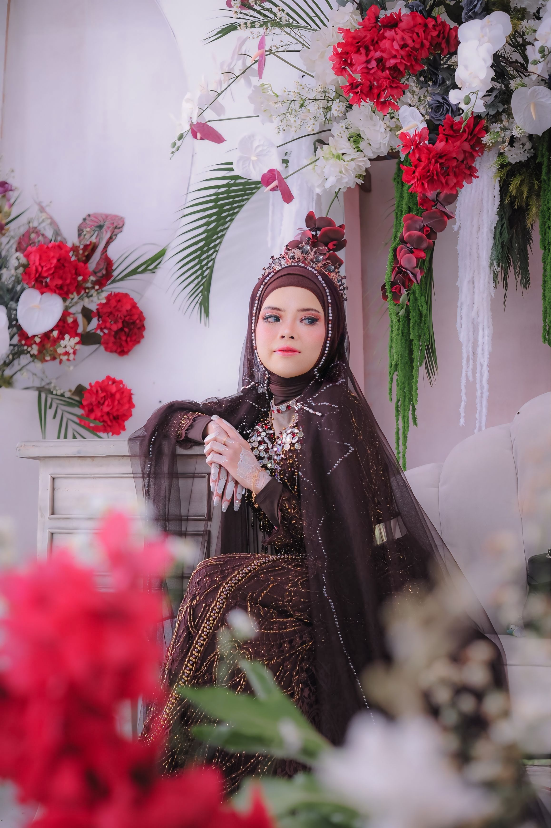 Elegant Woman in Traditional Attire Amidst Floral Decor