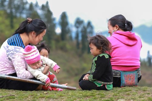 Free A candid portrayal of a family enjoying outdoor time in Lào Cai, Vietnam. Stock Photo