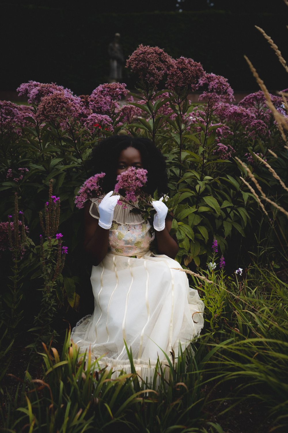 Woman in Elegant Dress Among Tall Pink Flowers · Free Stock Photo