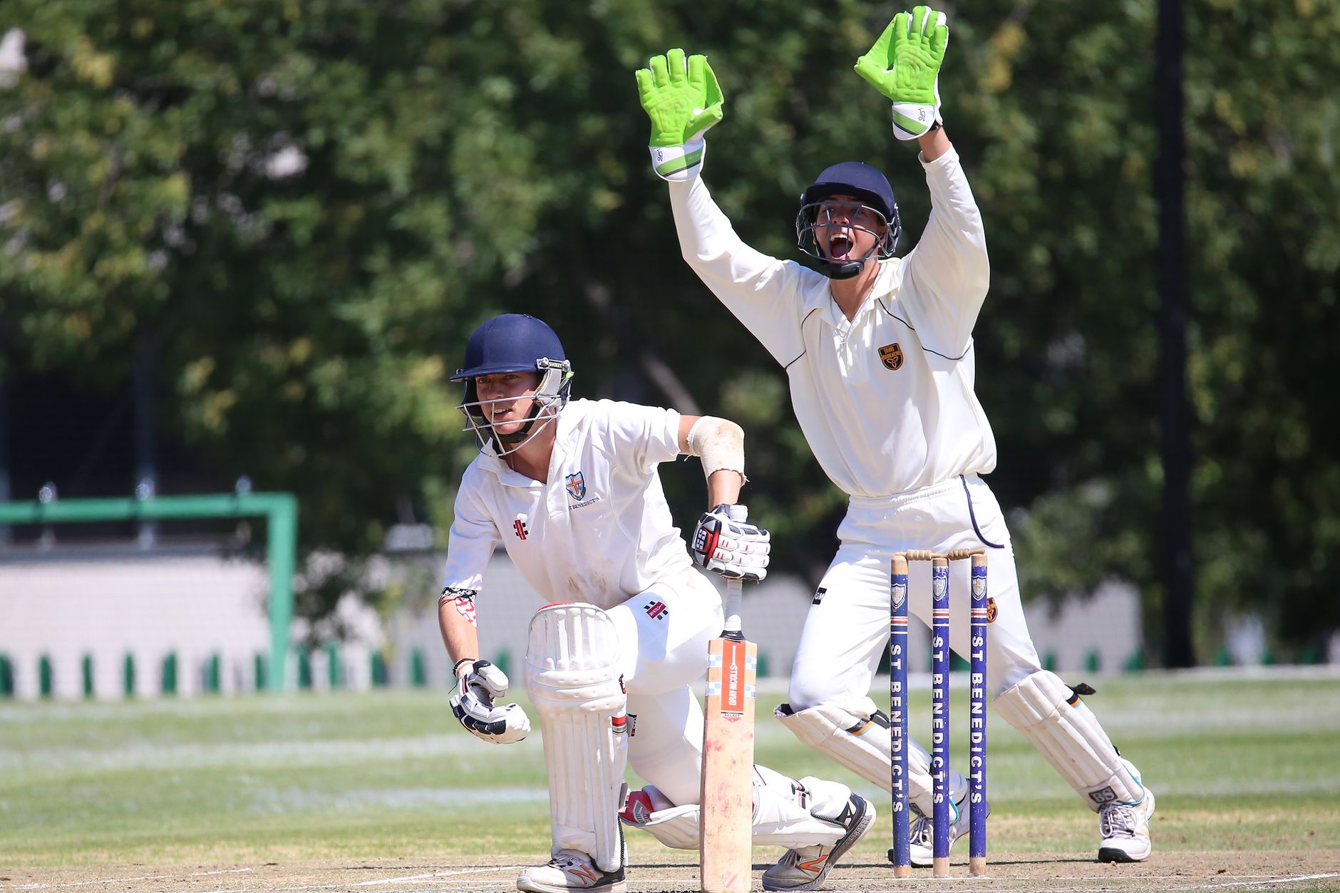 Dramatic moment in a cricket match with a batsman and wicketkeeper in action.