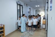 School Children Walking Through Hallway with Teacher
