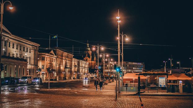 Elegant nighttime cityscape featuring historic architecture and street lighting.