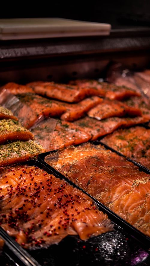 Free Close-up of raw salmon fillets seasoned with herbs, ready for cooking. Stock Photo