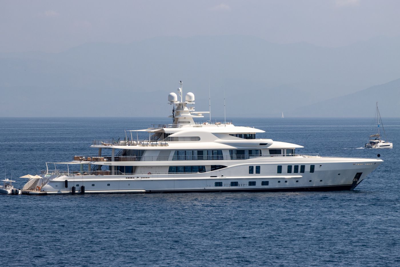 A white yacht under way on the Ionian Sea off Corfu, Greece, under a clear sky
