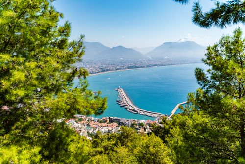 Free Stunning aerial view of Alanya harbor and cityscape with mountains and blue sea. Stock Photo