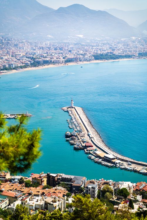 Free Stunning aerial view of Alanya Harbor with the cityscape and Taurus Mountains in the background. Stock Photo