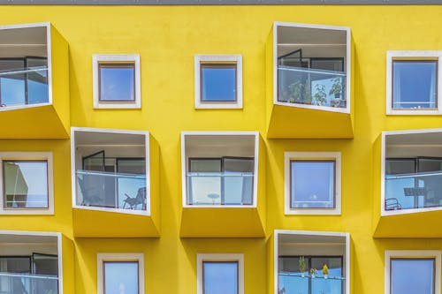 Yellow Concrete Building With Glass Windows