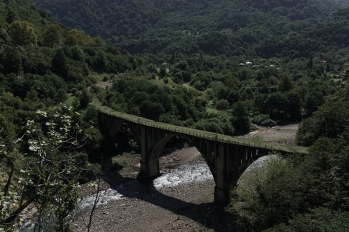 Free A picturesque bridge surrounded by lush greenery in Tkvarchali, showcasing nature's beauty. Stock Photo