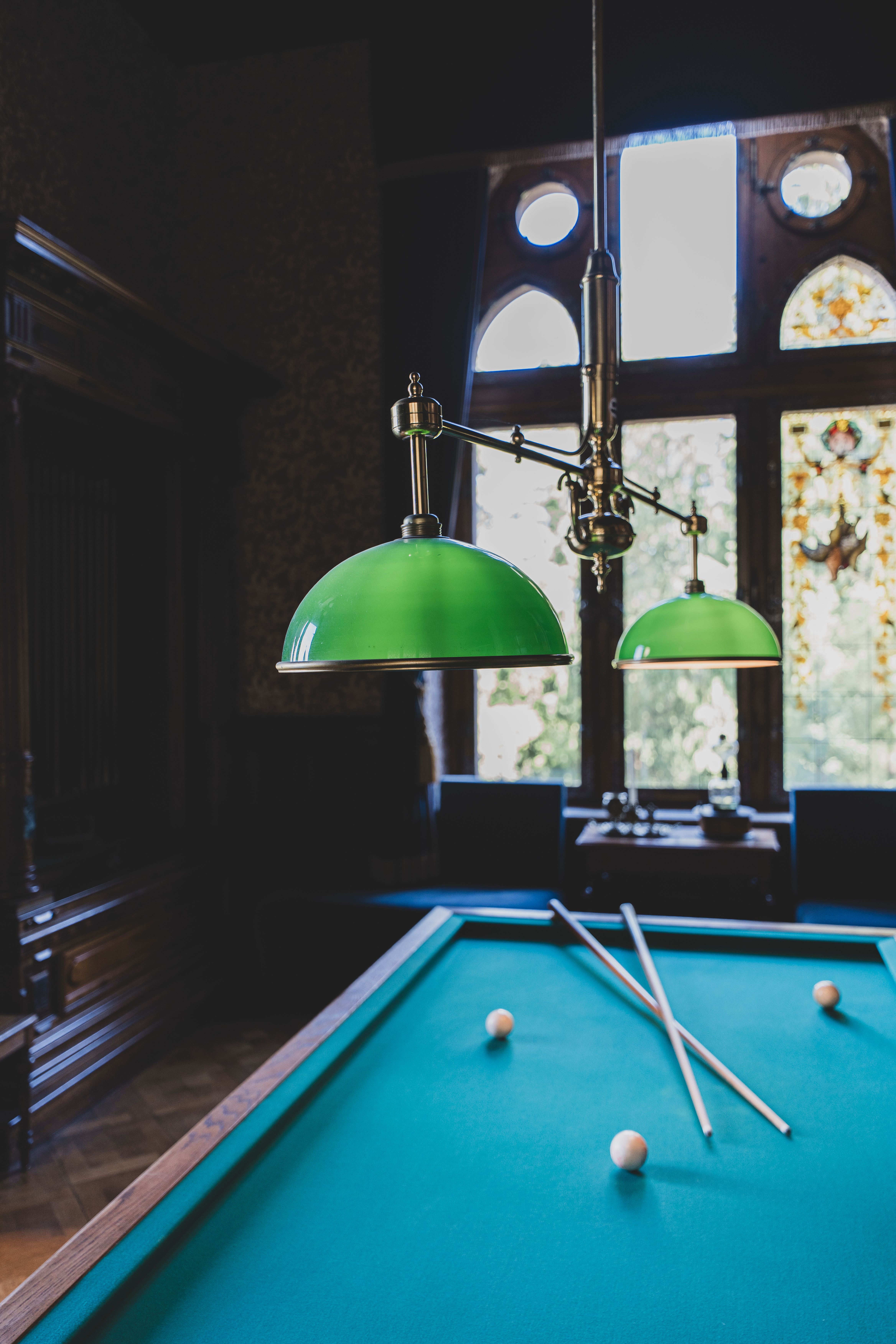 Elegant Billiard Room Interior with Green Lamps · Free Stock Photo
