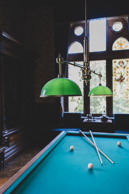Elegant Billiard Room Interior with Green Lamps · Free Stock Photo