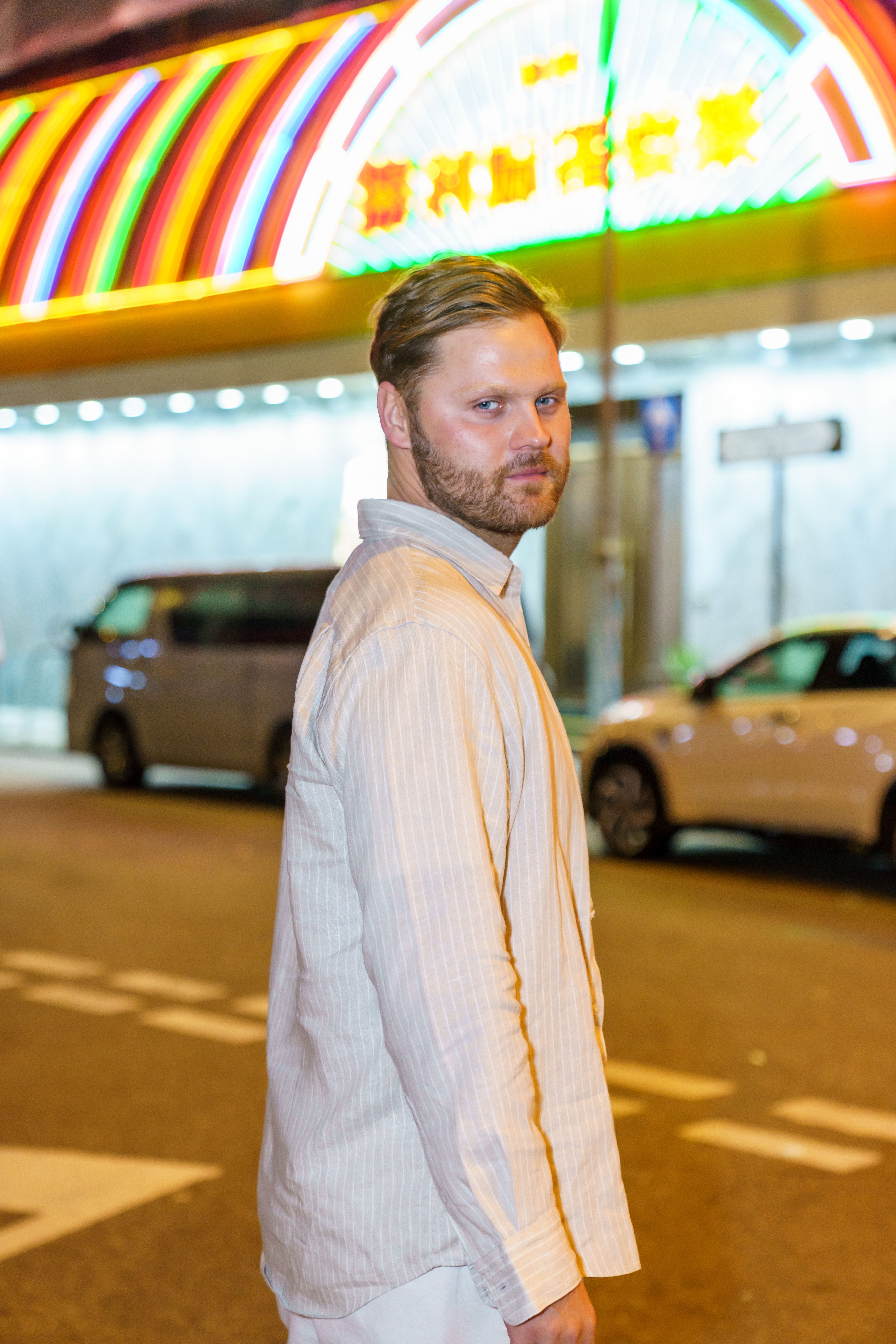 Man Standing on City Street at Night with Neon Lights · Free Stock Photo
