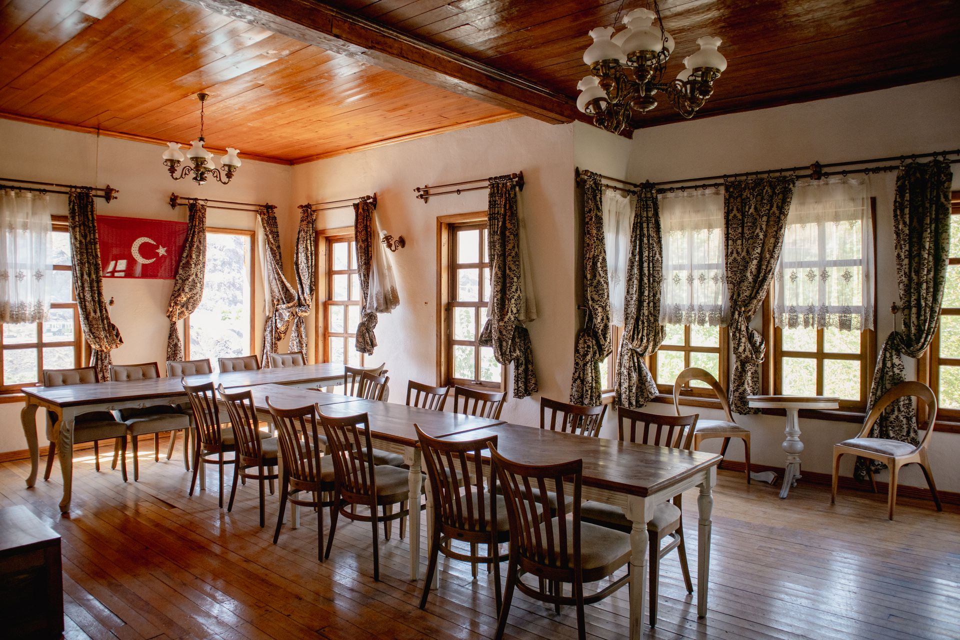 Sunlit traditional Turkish dining room with elegant decor and wooden furnishings.