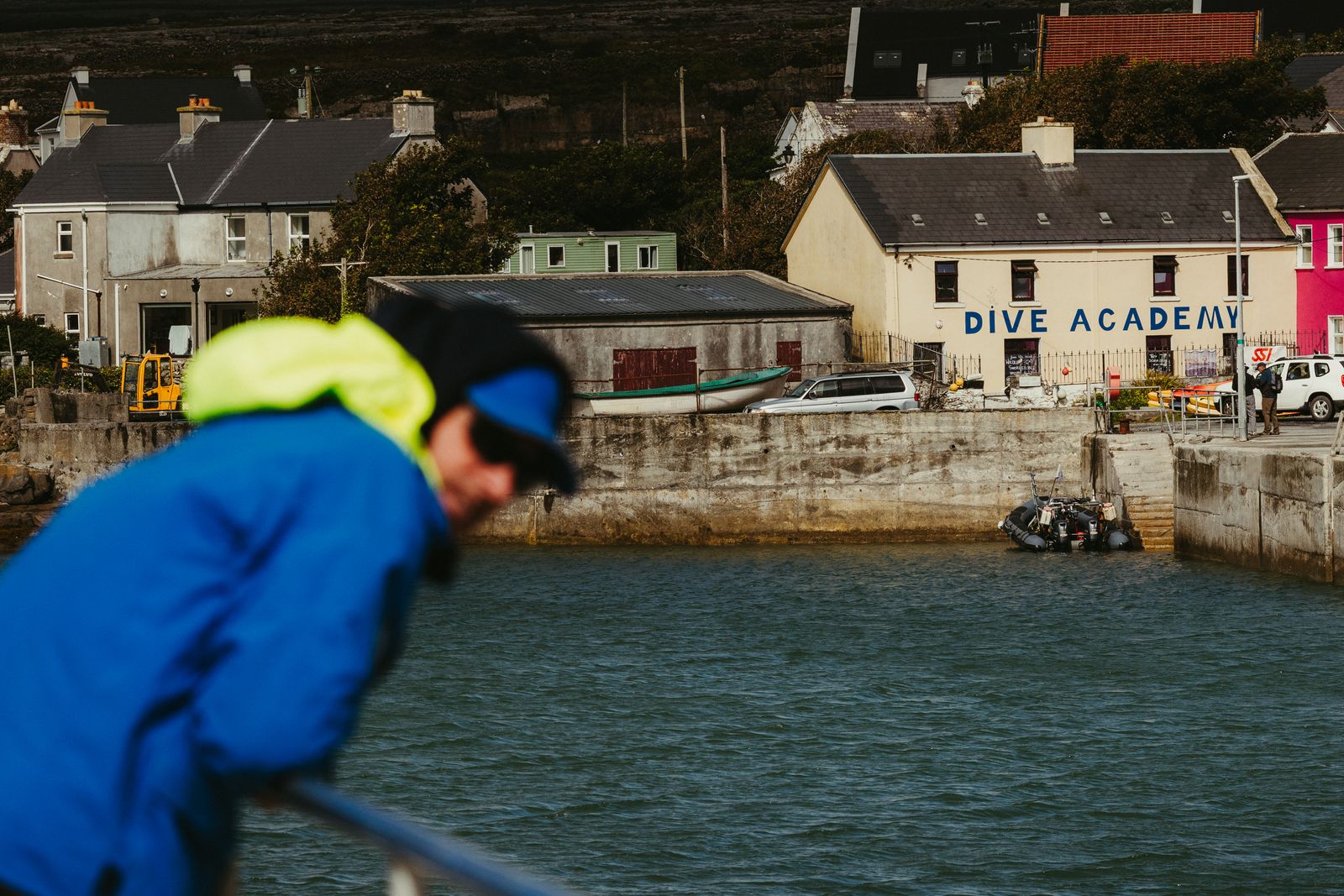 A person enjoys the coastal scenery by the Dive Academy in County Galway, Ireland