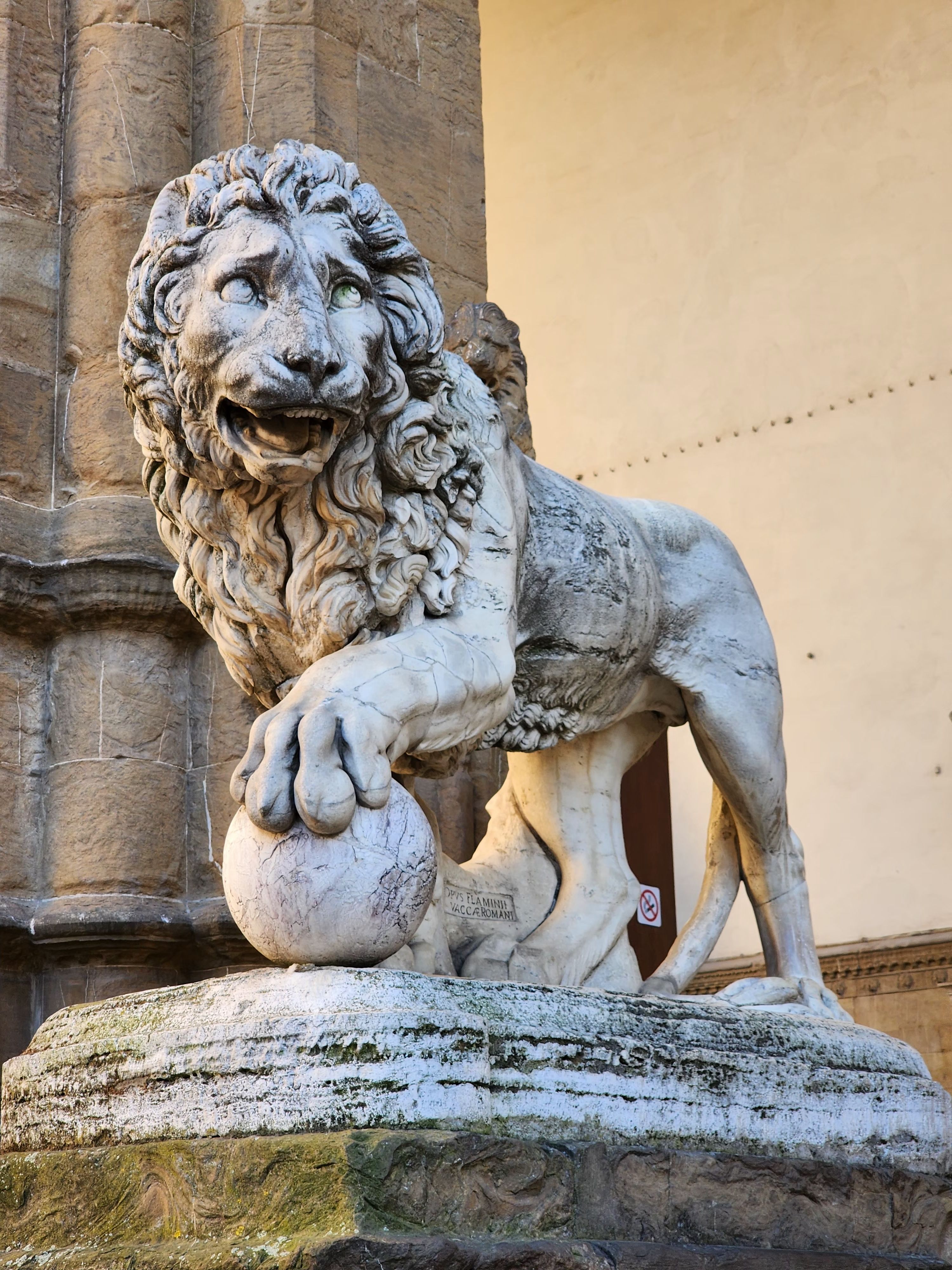 Detailed view of a Medici lion sculpture at the entrance of Loggia dei Lanzi, Florence, Italy