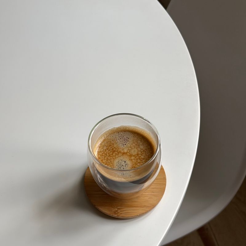Single espresso in a small glass on white — photo by نشمـيّـه on Pexels