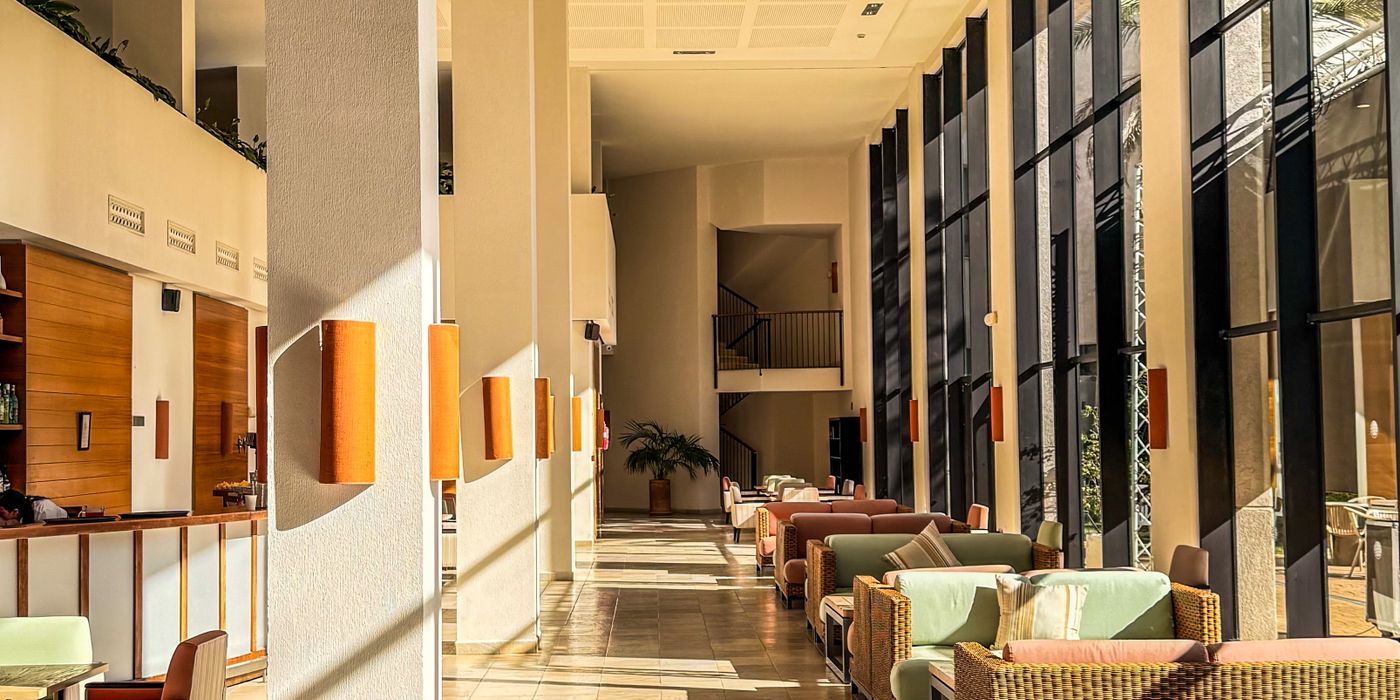 Bright modern hotel lobby with sunlight and contemporary seating