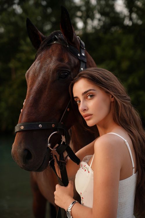 Free Young woman embraces a horse outdoors, showcasing a serene bond. Stock Photo